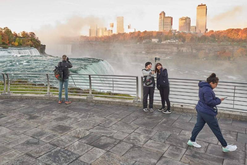 People take a selfie at the American Falls in Niagara Falls, New York on October 25, 2022.