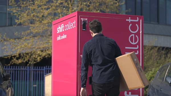 Man collecting parcel from shift locker pick-up point