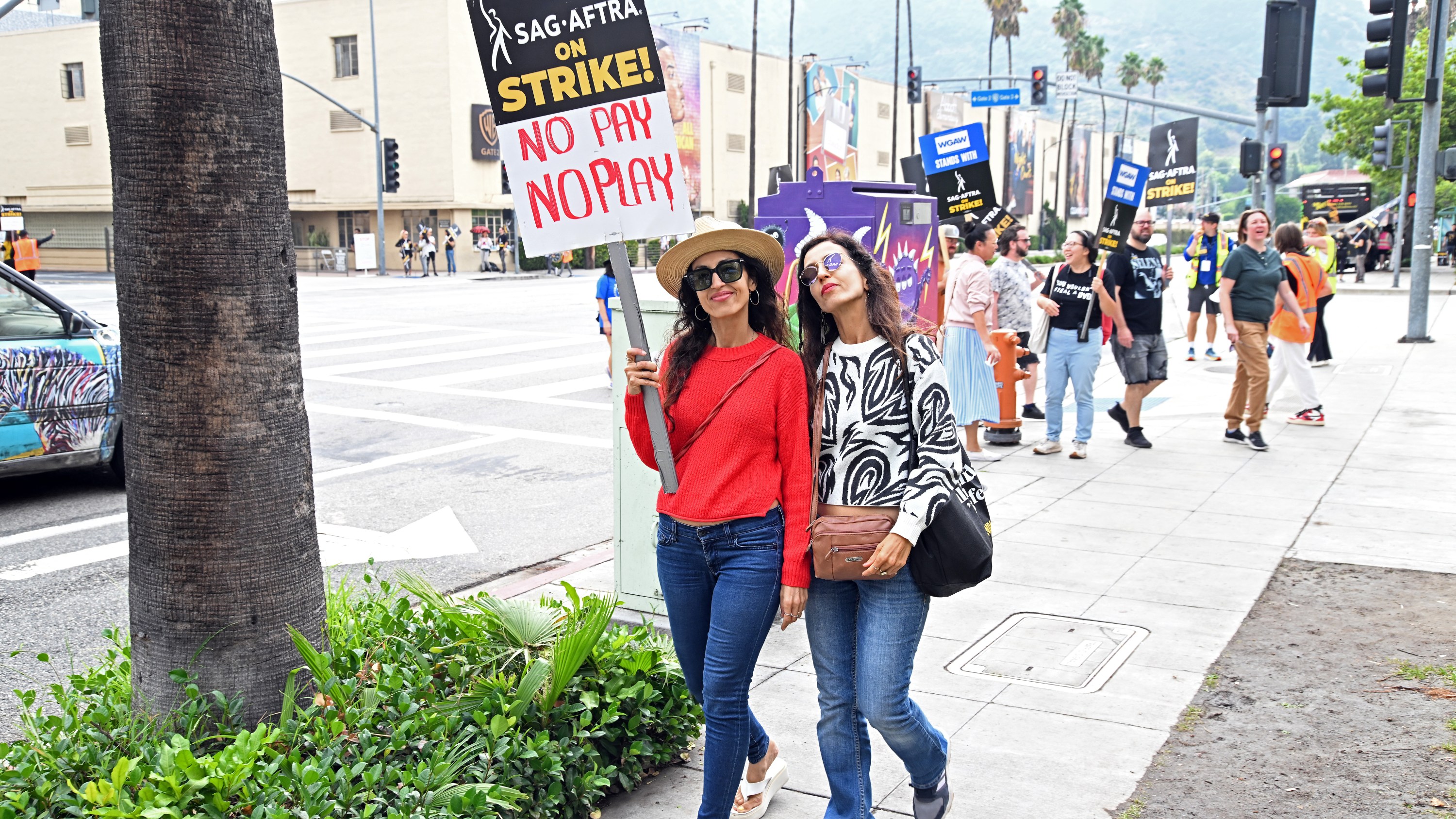 LOS ANGELES, CALIFORNIA - OCTOBER 10: A pair of striking actors attend the SAG-AFTRA picket lines on October 10, 2023 in Los Angeles, California. The WGA (Writers Guild of America) has reached a deal with Hollywood studios after 146 days on strike, ending their strike at midnight on September 27. Members of SAG-AFTRA and WGA (Writers Guild of America) walked out in their first joint strike against the studios since 1960, shutting down a majority of Hollywood productions. SAG-AFTRA has not reached a deal with the studios and has been on strike since July 14. (Photo by Michael Tullberg/Getty Images)