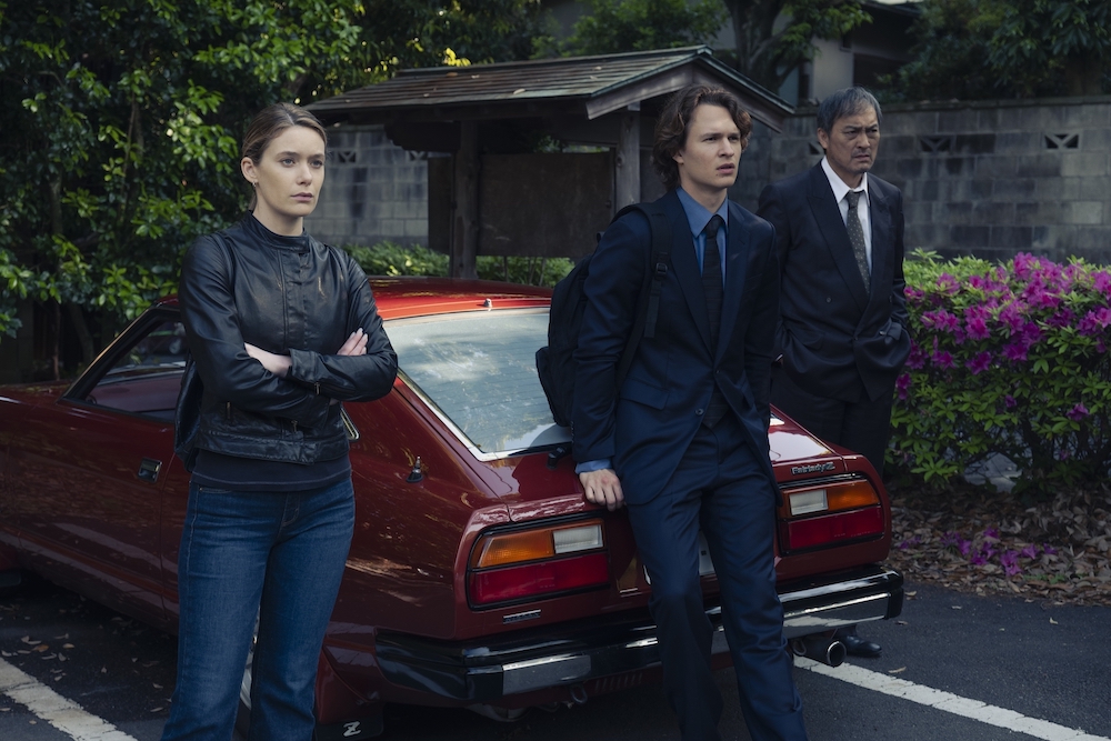 Rachel Keller, Ansel Elgort, and Ken Watanabe lean against a car in 'Tokyo Vice' Season 2, Episode 10