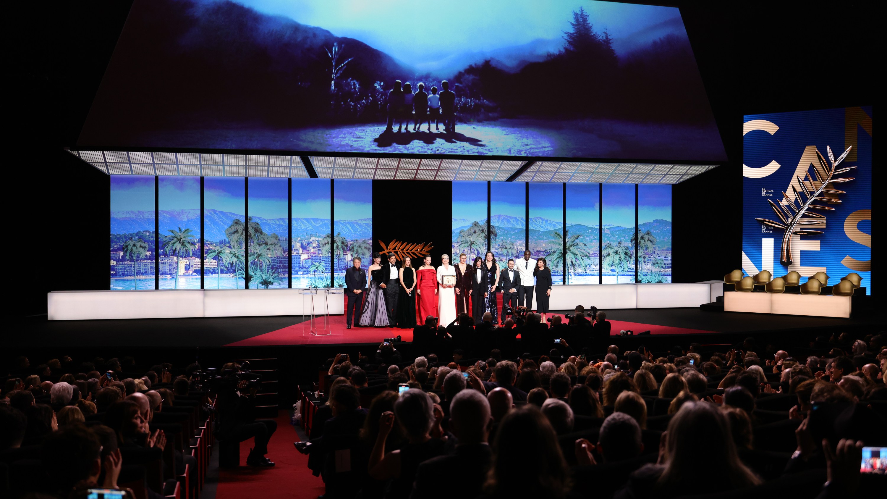 CANNES, FRANCE - MAY 14: (L-R) Jury member Hirokazu Kore-eda, jury member Eva Green, jury member Pierfrancesco Favino, Mistress of ceremonies Camille Cottin, Juliette Binoche, Meryl Streep with the Honorary Palme D’Or Award, President of the Jury Greta Gerwig, jury members Nadine Labaki, Lily Gladstone, Juan Antonio Bayona, Omar Sy and Ebru Ceylan pose on stage during the opening ceremony at the 77th annual Cannes Film Festival at Palais des Festivals on May 14, 2024 in Cannes, France. (Photo by Andreas Rentz/Getty Images)