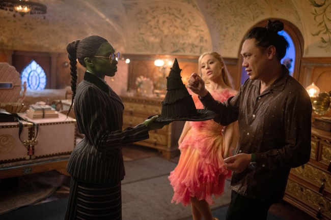 WICKED, from left: Cynthia Erivo, Ariana Grande, director Jon M. Chu, on set, 2024.  ph: Giles Keyte /© Universal Pictures / Courtesy Everett Collection