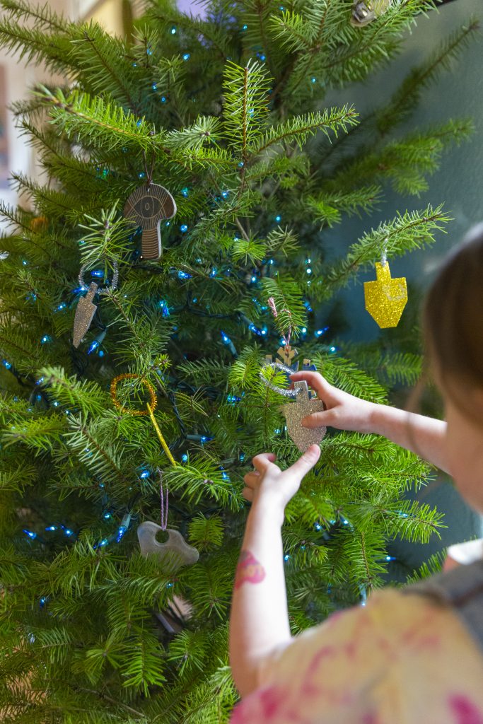 Decorating a tree with Hanukkah ornaments. (EyeWolf/Getty Images)