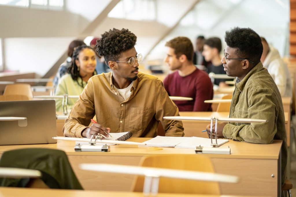 Students discussing in groups in a classroom. (Vladimir Vladimirov/Getty Images)