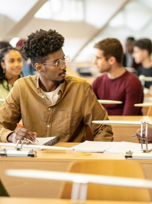 Two students chatting while in the classroom