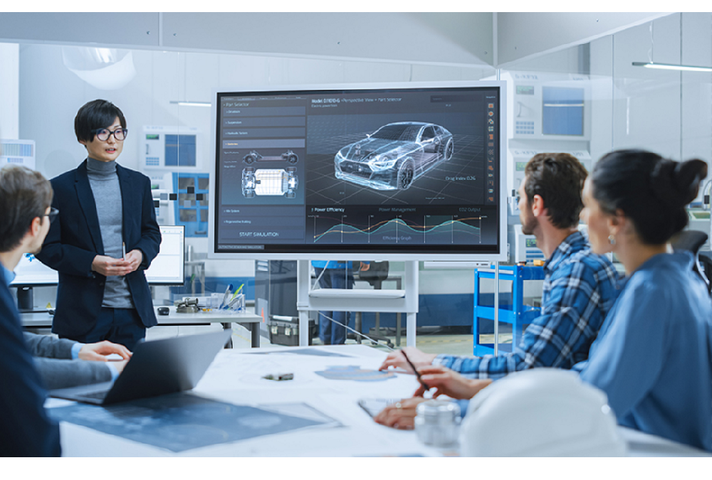 A team having a meeting at the office with a picture of an automobile displayed on a screen