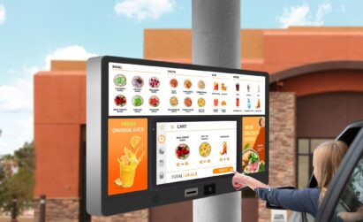 A woman interacting with an outdoor digital menu board