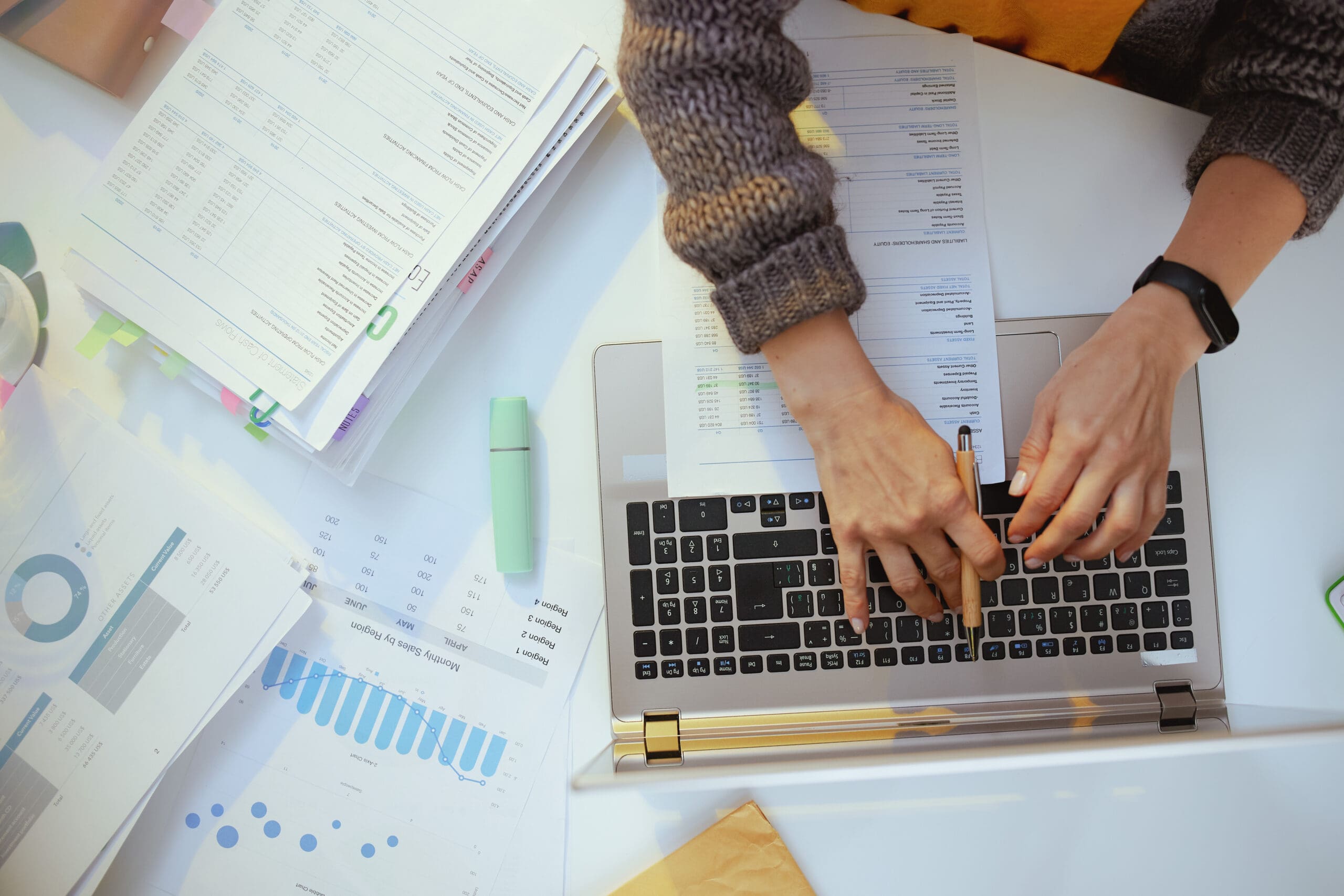 self employed person with documents and laptop working.