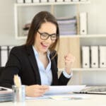 Excited businesswoman checking gorwth graph at office