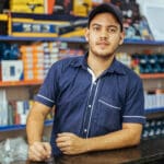 Young latin man working in hardware store