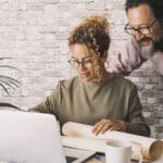 Couple of worker busy in home office alternative workplace with small business job activity together. People work and use computer indoor. Concept of smart working remote telecommuting with technology