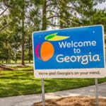 State sign for Georgia welcomes visitors in a shaded rest area