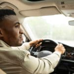 African american man driving a modern car. High quality photo