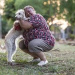 Portrait of a Latin woman taking her cute dog for a walk on the streets and in a public park, in a relaxing mood.