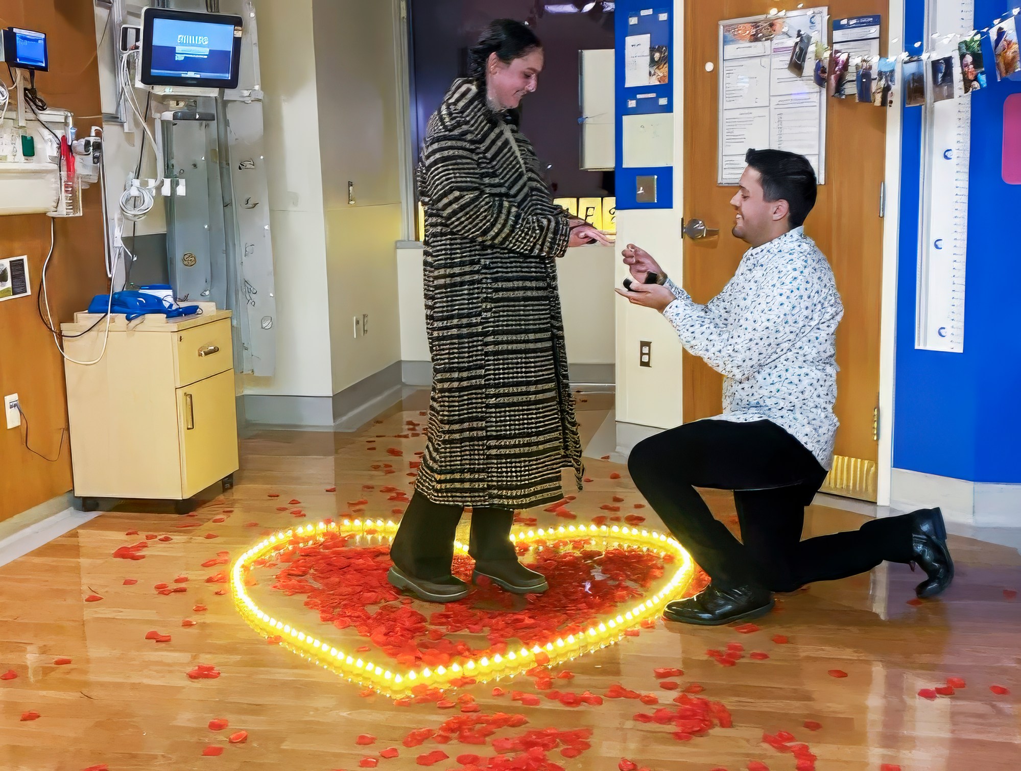 Nick Meza proposes to Lauren Aslanian at CHOC on Thursday, Dec. 19 in Orange. The couple met 10 years earlier when they were both undergoing cancer treatment at CHOC. ....Nick planned the whole proposal and designed the ring himself. The inside of the ring has the CHOC coordinates and a stone the color of each of their cancer ribbons. On the night of the AYA holiday party the AYA team devised a plan to have Lauren come and mentor a patient on the floor while a child life specialist snuck Nick through the basement and got him in the room before Lauren arrived. A CHOC staffer brought her to the room where she thought she was meeting another AYA member and then Nick was in there...(Courtesy CHOC)