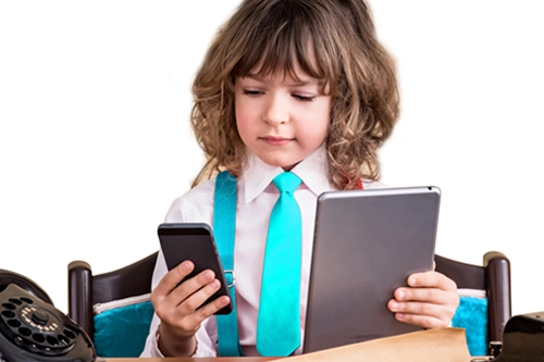 young girl dressed as business woman looking at mobile devices