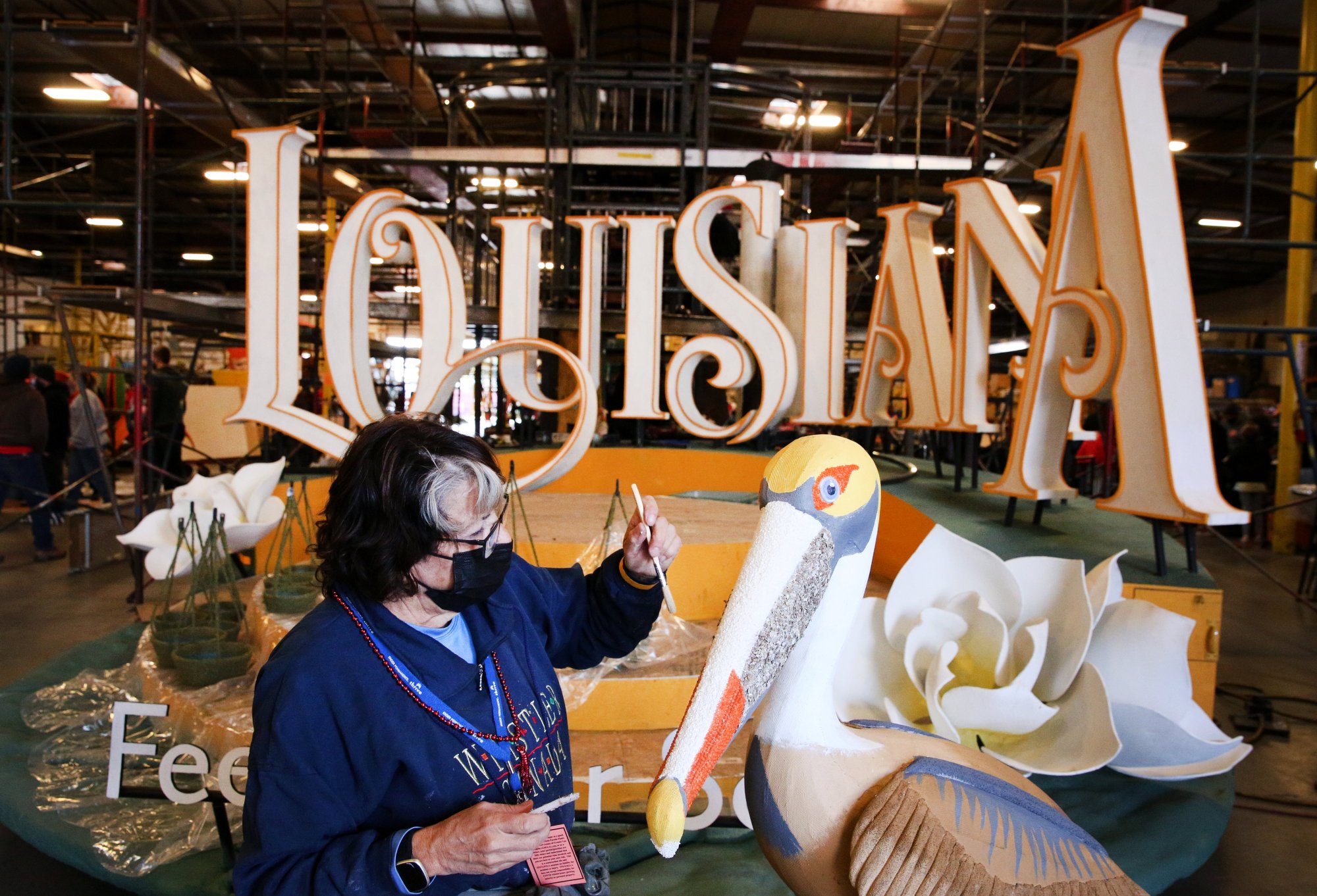 Pauline Annarino, 70, of Covina, works on the Louisiana Office of Tourism float at Fiesta Parade Floats in Irwindale, Calf., ahead of the 2022 Rose Parade on Monday, Dec. 27, 2021. (Photo by Trevor Stamp, Contributing Photographer)