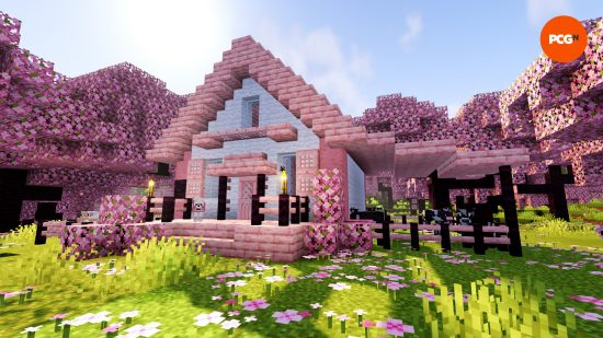 A pink, cherry wood Minecraft house design built in a cherry grove biome.