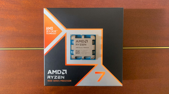 AMD Ryzen 7 9800X3D review: Gaming CPU on top of box with wooden background.