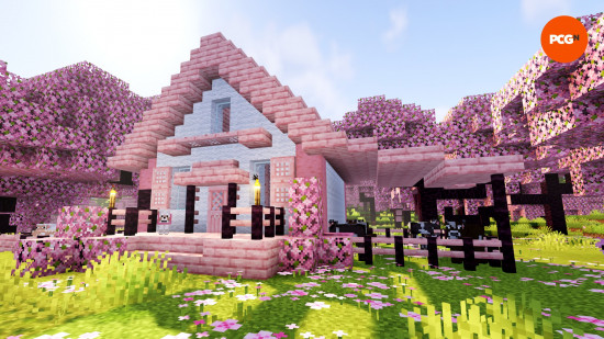 A pink and white Minecraft house built from cherry wood.