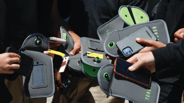 Students unlock their cellphones from pouches that secure them during the school day at Bayside Academy in San Mateo, California. The school district banned cellphones on its four middle school campuses in 2022. (Lea Suzuki/San Francisco Chronicle via Getty Images)