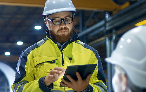 person with a tablet wearing a helmet