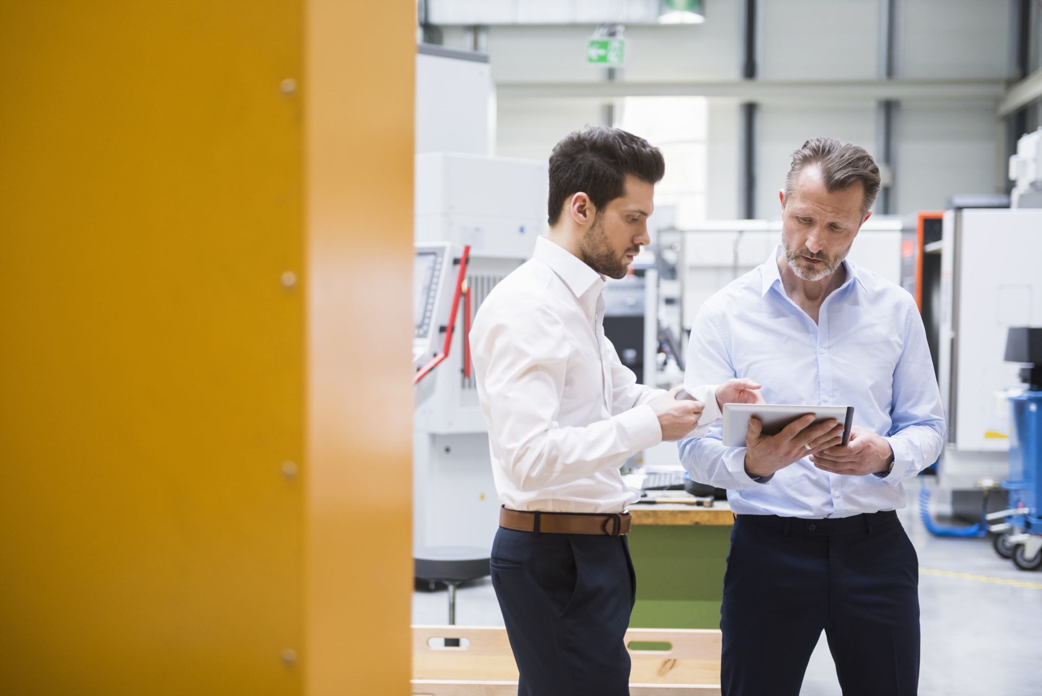 two people with a tablet in the office