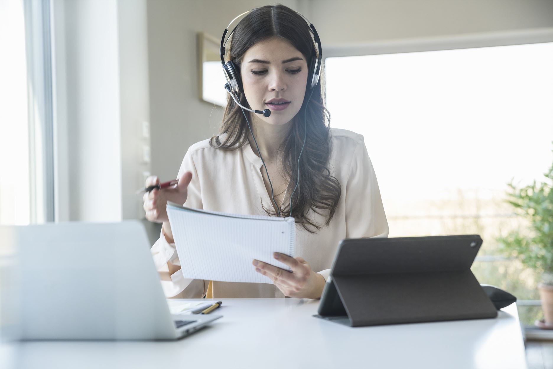 woman with earphones and microphone assisting