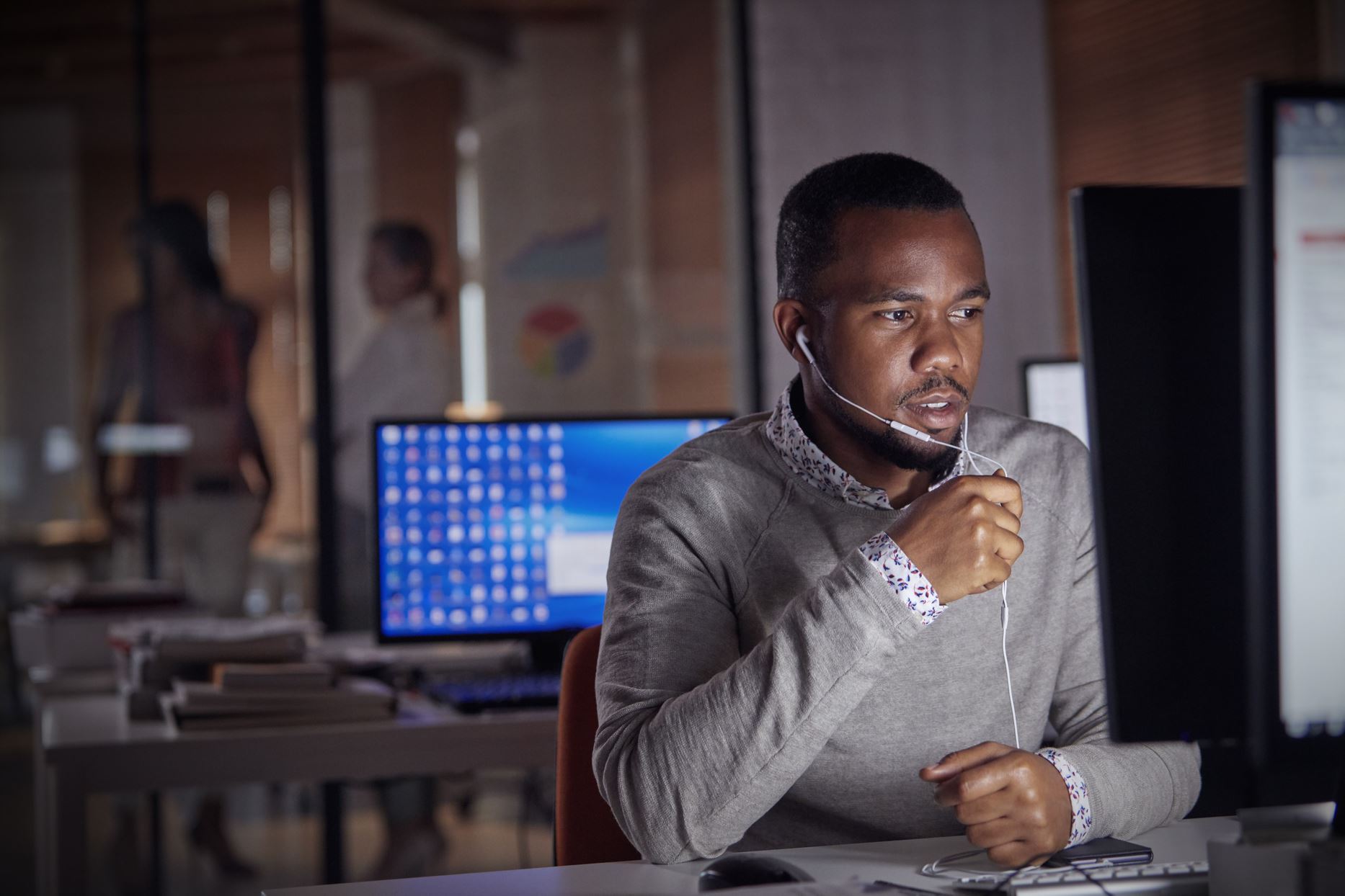 person talking to someone over the computer with earphones on