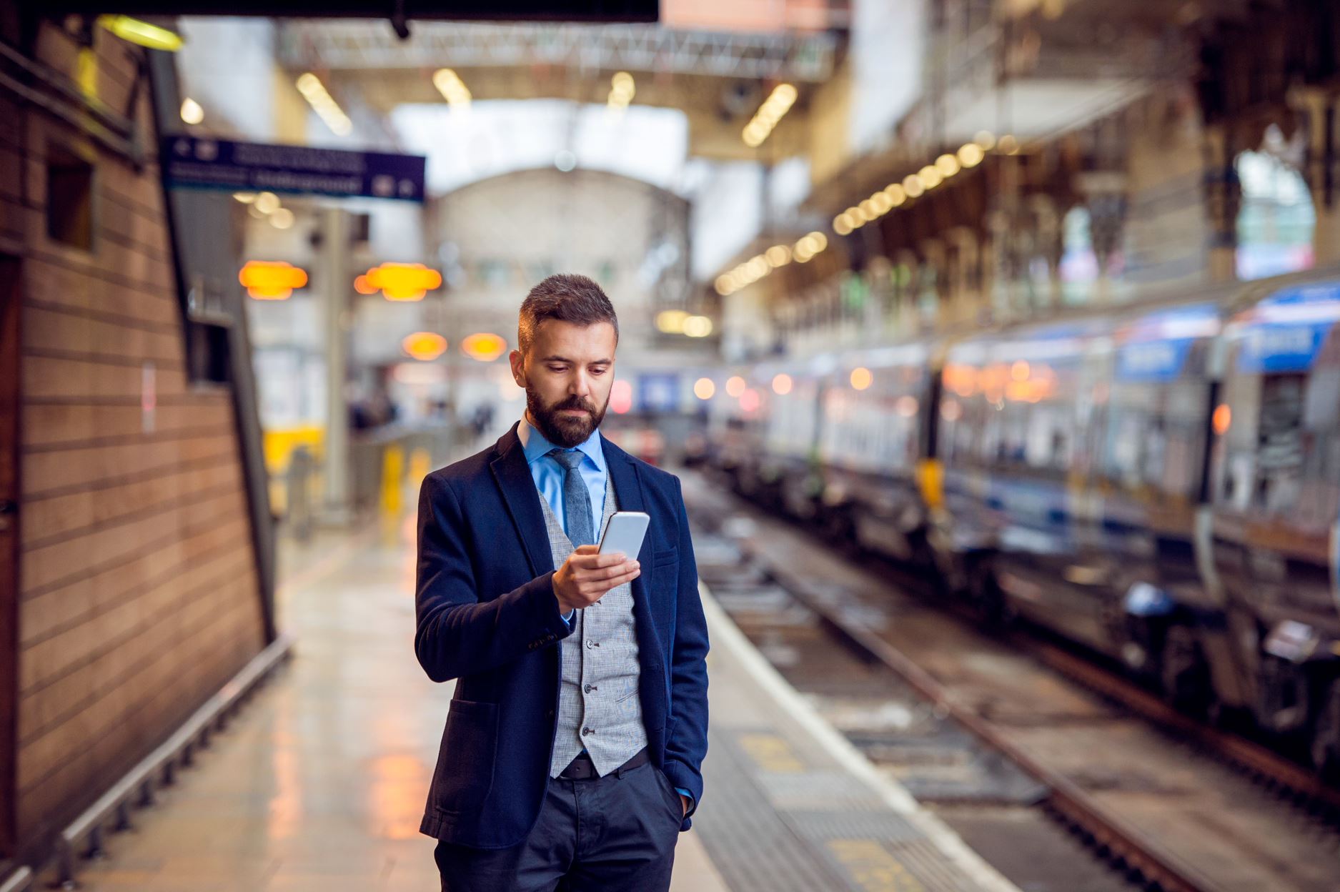 person in suits with a phone in the subway