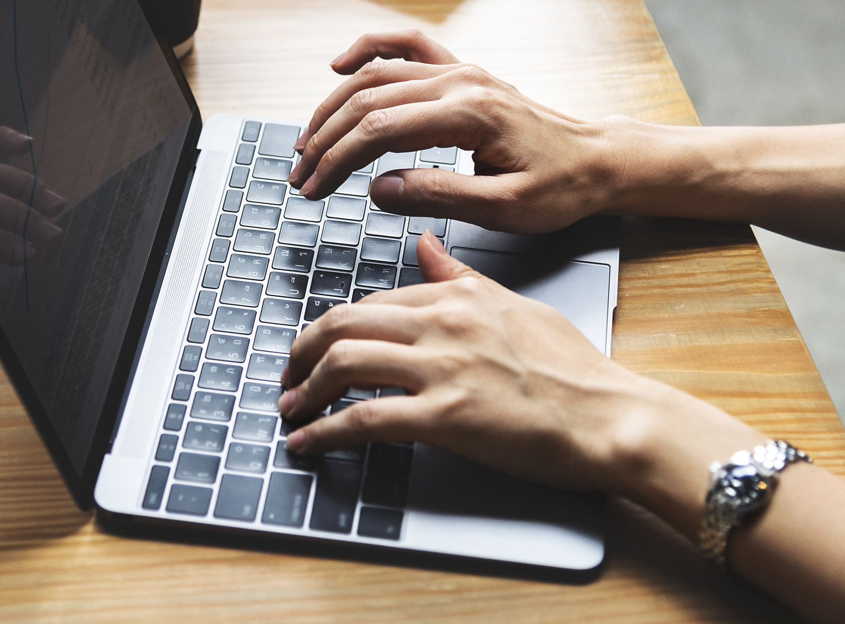 person typing on a laptop