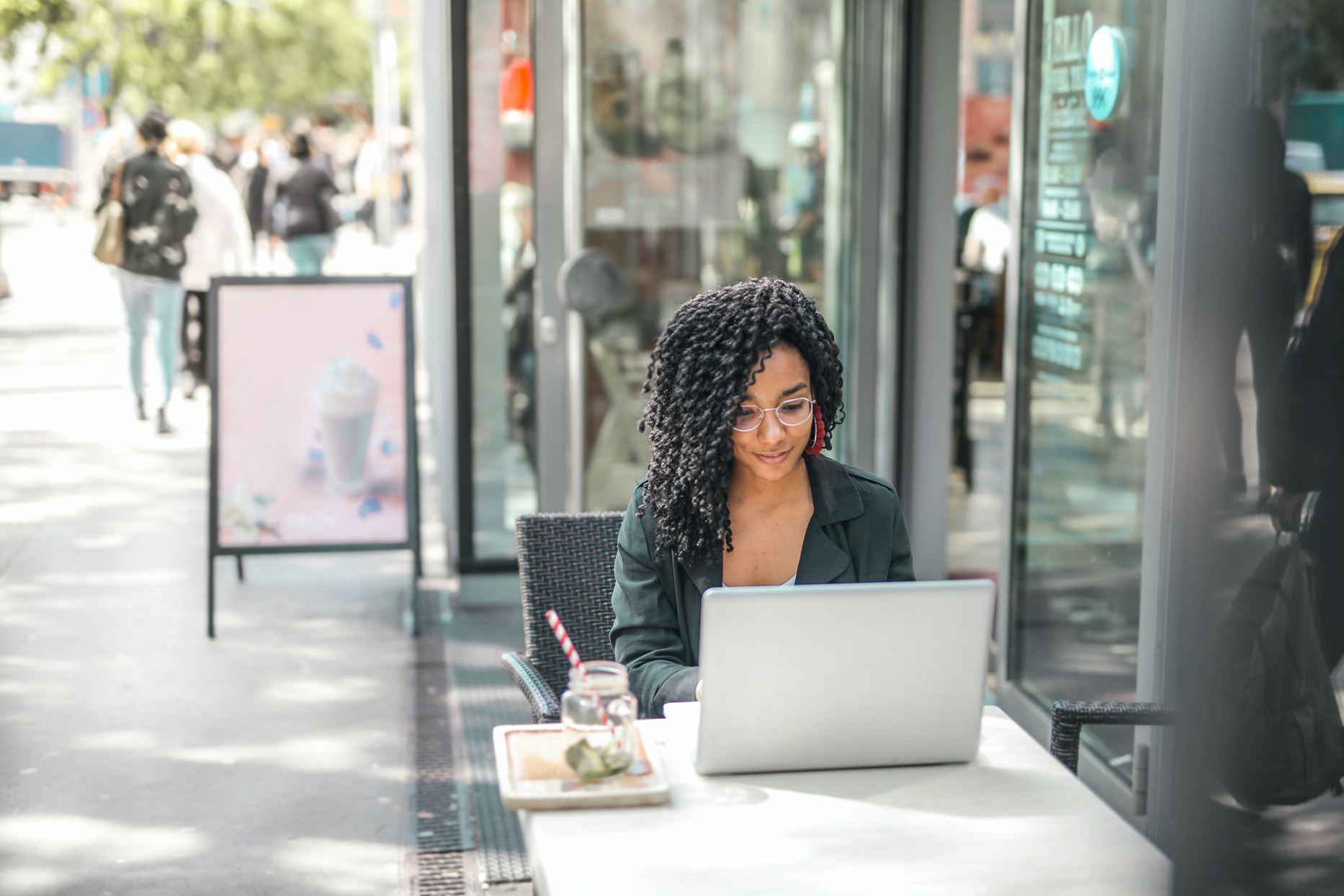 person working on her laptop at a cafe