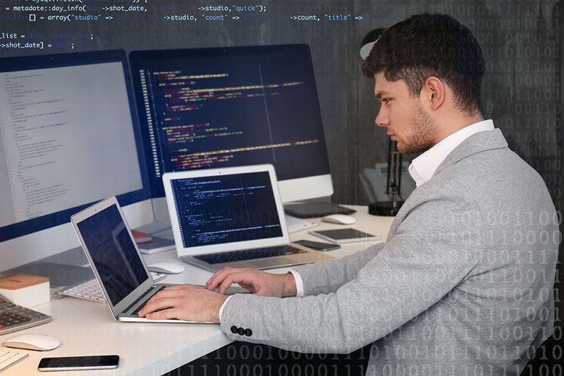 a man sitting and working on a computer