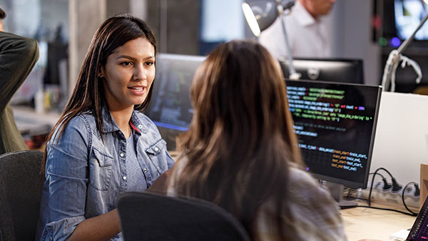 women talking while working