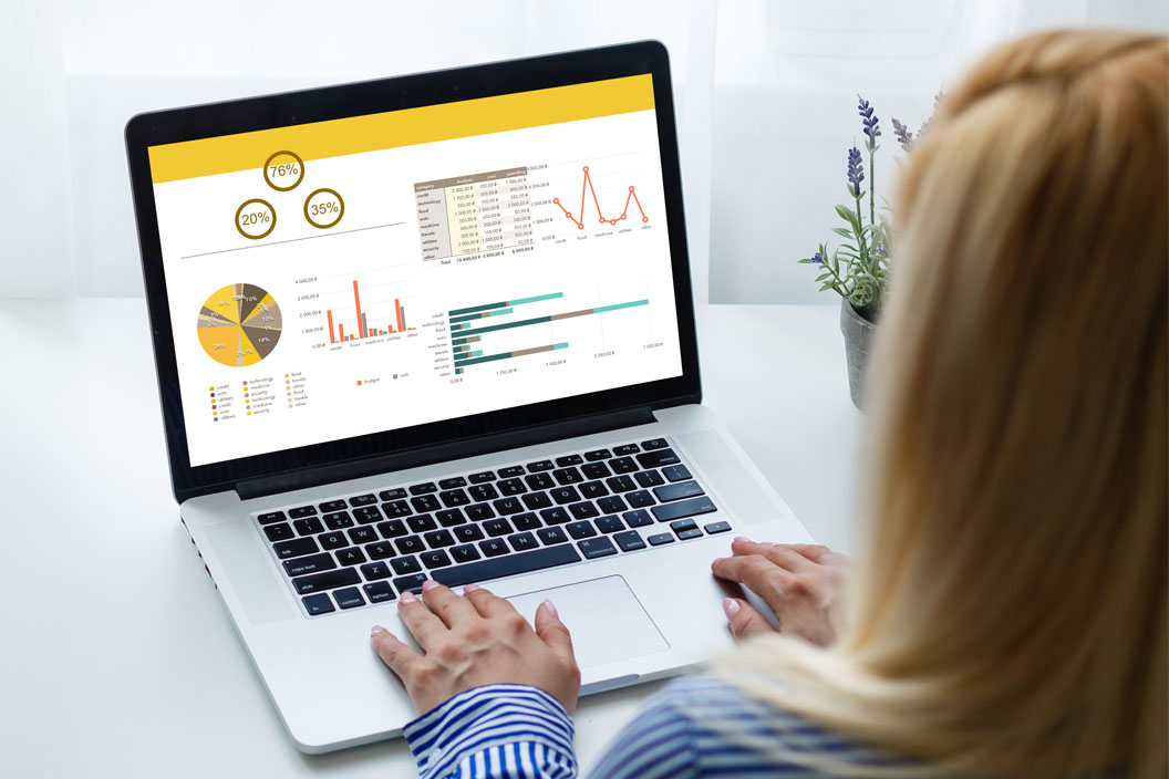 Woman working in her computer showing graph on the screen