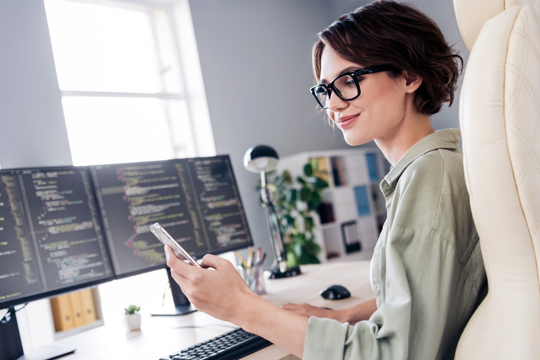 Woman looking at her phone while working