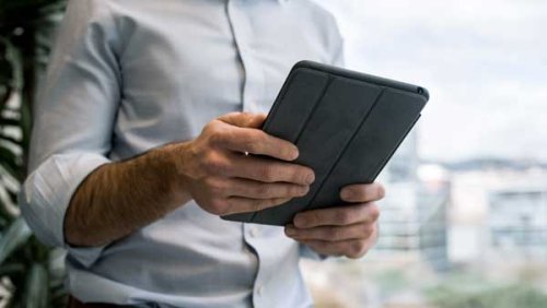 a man holding an iPad