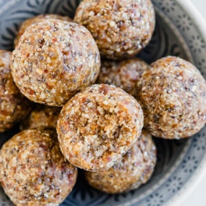 A bowl of granola balls on a table.