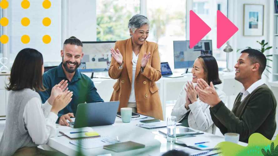 A group of people in a conference room celebrate Customer Service Week.