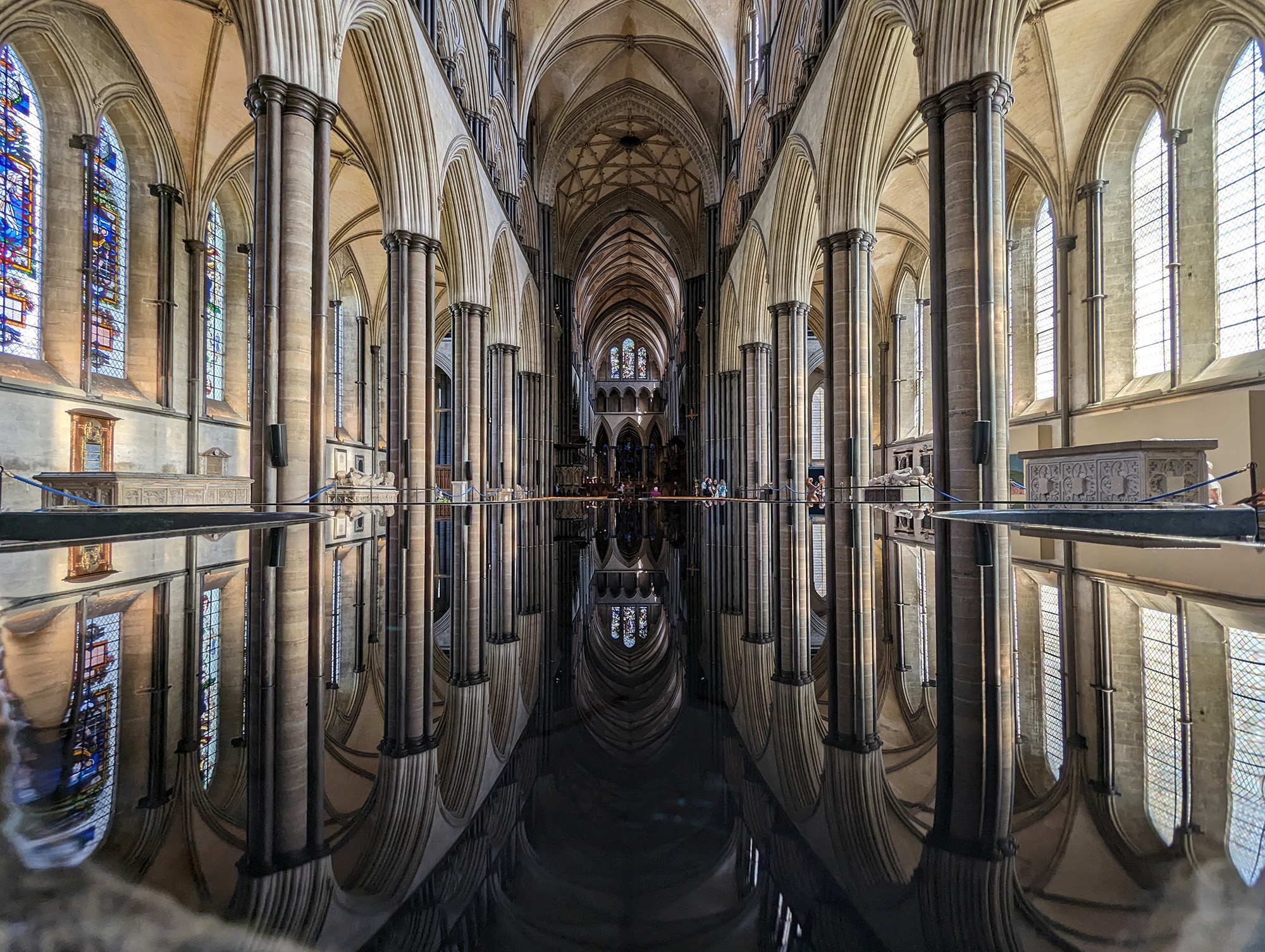 View of the inside of Salisbury Cathedral and a symmetrical reflection in the font