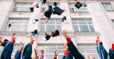 graduates throwing hats in the air