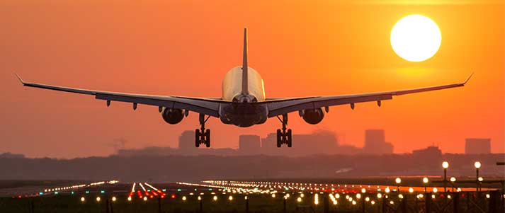 airplane landing at sunset