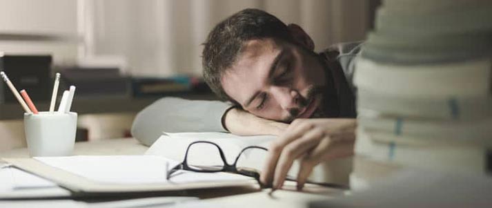 man sleeping on desk