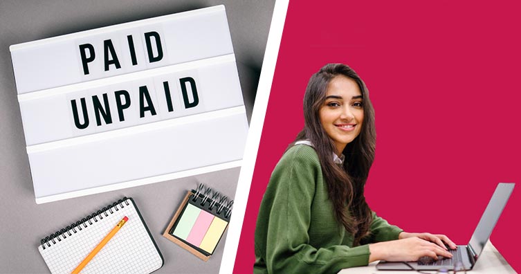 sign with words paid and unpaid and woman sitting behind laptop