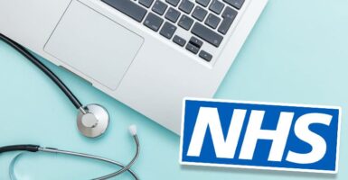 Laptop, stethoscope and NHS logo