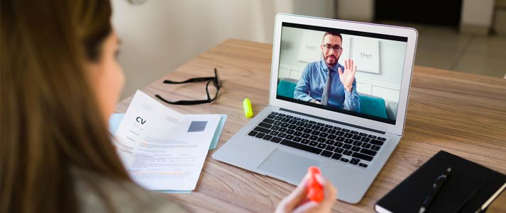 Woman having video interview on laptop