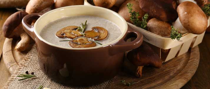 Mushroom soup with mushrooms on chopping board