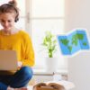 woman with laptop, map, suitcase and briefcase