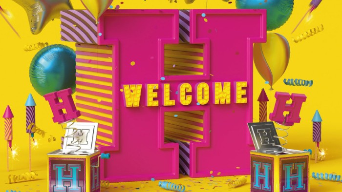 A vibrant and celebratory image with a large pink letter "H" at the center. The word "Welcome" is displayed in bold letters across the "H". Colourful balloons, fireworks, confetti, and spring-loaded boxes surround the H.