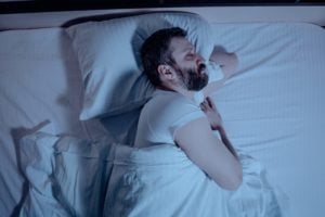 man sleeping in bed